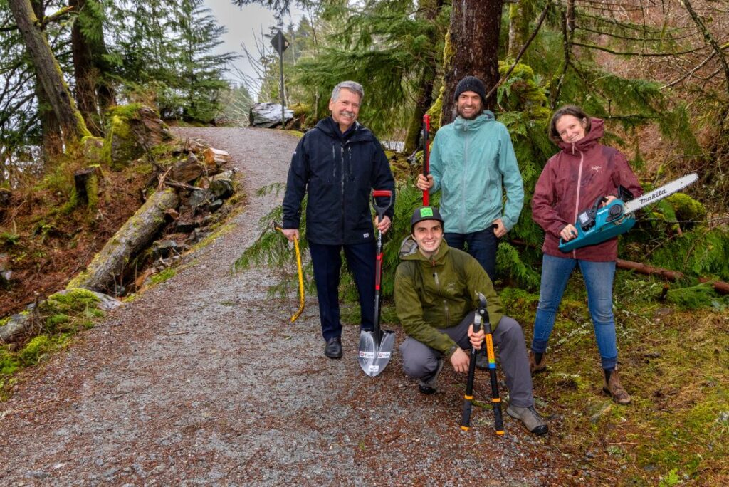 Trigon CEO Rob Booker (left) is seen here with Kaien Trails Society Directors Sean Carlson (kneeling), Steve Milum and Frances Riley.